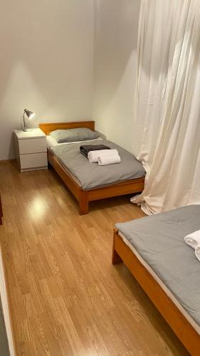 a bedroom with two beds and a lamp on a table at Apartment seafront Juraj in Tribunj