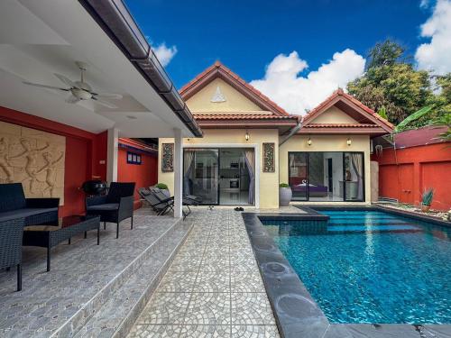 a villa with a swimming pool and a house at VIEW TALAY VILLAs POOL 119, JOMTIEN BEACH, PATTAYA in Jomtien Beach