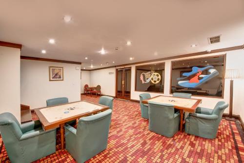 a conference room with two tables and chairs at Pearl Continental Hotel, Bhurban in Bhurban