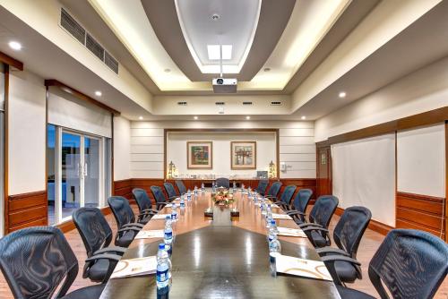 a conference room with a long table and chairs at Pearl Continental Hotel, Bhurban in Bhurban