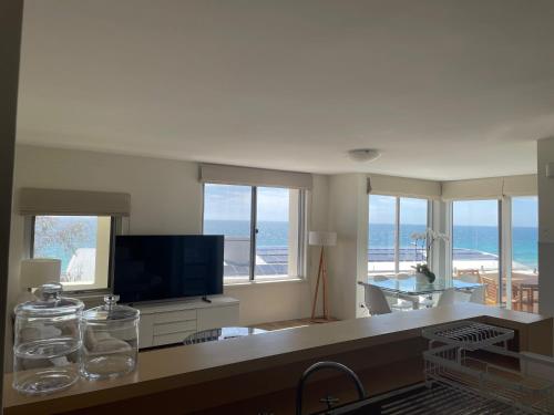 a living room with a view of the ocean at Cottesloe Beach View Apartments No.8 in Perth