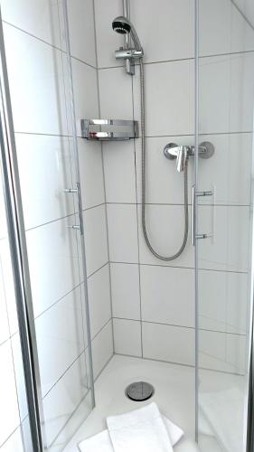 a bathroom with a shower with a glass door at Wohnung-Moewe-2 in Westerland (Sylt)