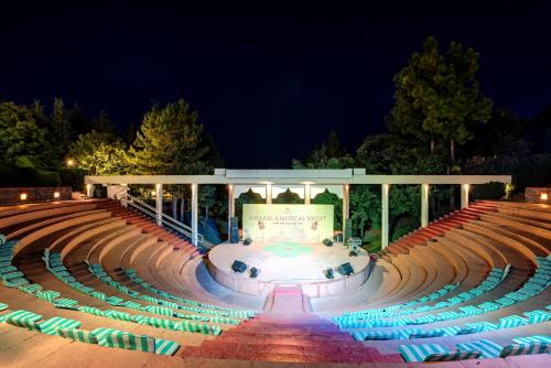 a large amphitheater with a fountain at night at Pearl Continental Hotel, Bhurban in Bhurban