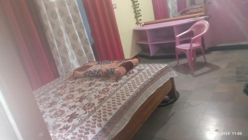 a bedroom with a bed and a piano at SAI homestay in Hospet