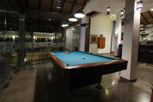 a pool table in the middle of a room at Garton's Cape in Ahangama