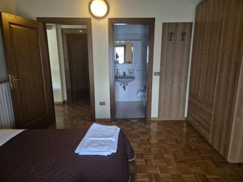 a bedroom with a bed and a bathroom with a sink at Villa San Giuseppe in Brescia
