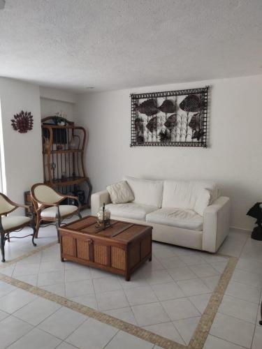 a living room with a couch and a coffee table at Costa Azul a 100 mts playa in Acapulco
