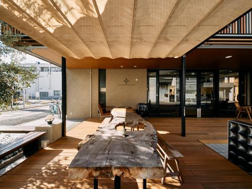 a large wooden table in the middle of a room at Kyoto Guesthouse HIVE in Kyoto