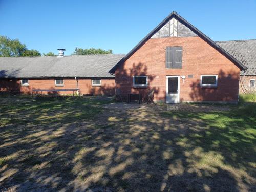 a large brick house with a yard in front of it at Nordborg Apartment Hejnsvi in Hejnsvig