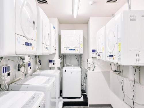 a laboratory with white machines and appliances at Kyoto Guesthouse HIVE in Kyoto