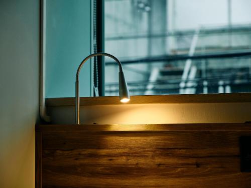 a light in front of a window in a room at Kyoto Guesthouse HIVE in Kyoto