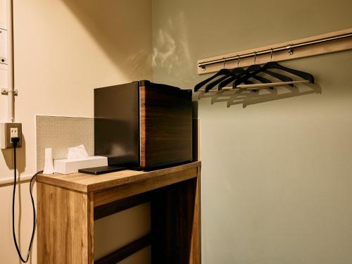 a microwave sitting on top of a counter in a room at Kyoto Guesthouse HIVE in Kyoto