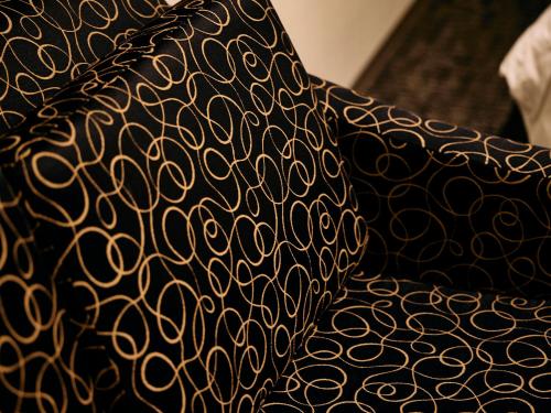 a black shirt with a gold pattern on it at Kyoto Guesthouse HIVE in Kyoto
