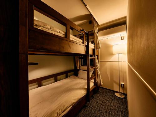 a bunk bed room with two bunk beds in it at Kyoto Guesthouse HIVE in Kyoto