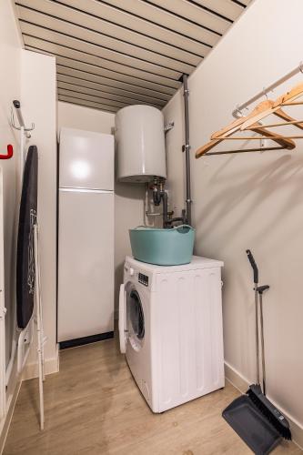a washer and dryer in a room with a ceiling at House 22 longstay in Kortrijk
