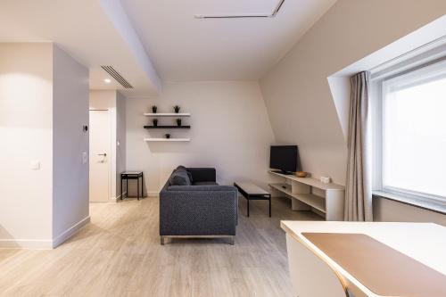 a living room with a couch and a window at House 22 longstay in Kortrijk