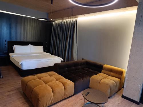 a bedroom with a bed and a couch and a bed at Toka Hotel Restaurant in Pogradec