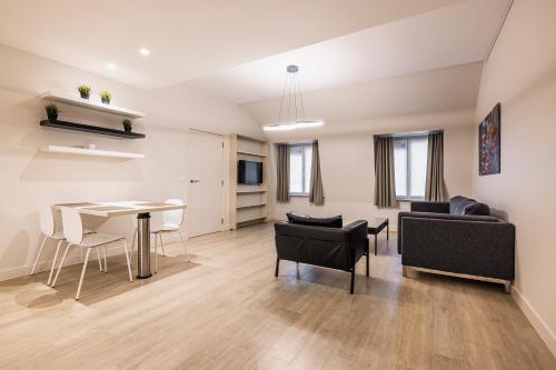 a living room and dining room with a table and chairs at House 22 longstay in Kortrijk