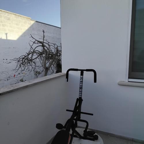 a room with a treadmill next to a window at B&B Passione Salento in Surbo