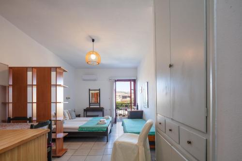a living room with a couch and a table at Old town studio with balcony, Marylee's studios #3 in Rethymno