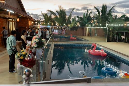 a swimming pool with a red swan in the water at D Banlieue Homestay And Coffee TP Kon Tum in Kon Tum