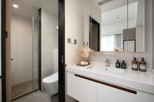 南京Nanjing Olympic Sports Center Suisse Place Apartment Hotel的带水槽、马桶和镜子的浴室