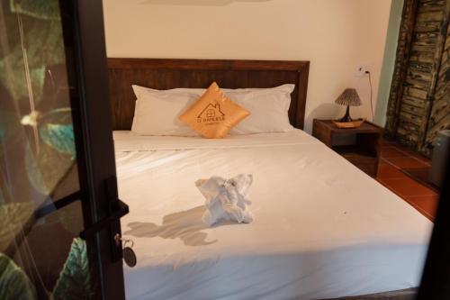 a bed with a stuffed animal sitting on top of it at D Banlieue Homestay And Coffee TP Kon Tum in Kon Tum