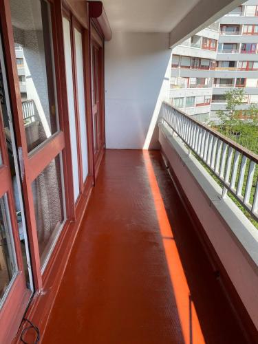 a corridor of a building with windows and a balcony at Liberté Room 2 Chambre privée en colocation conviviale ! in Nanterre