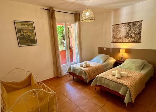 SantʼAntoninoにあるVilla Catalinaのベッド2台と椅子と窓のある寝室