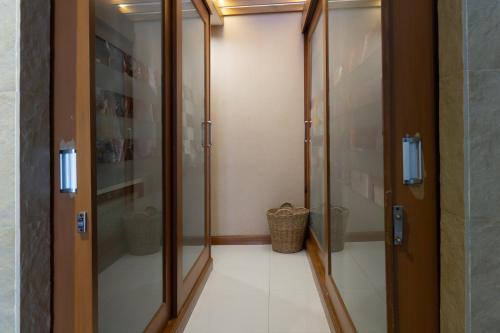 a corridor with glass doors in a room at Modern Home in Sukhumvit in Bangkok