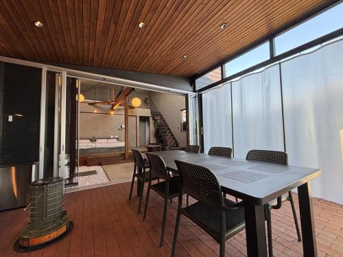 a dining room with a table and chairs at Villa CORTILE in Awaji