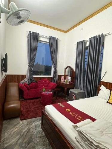 a bedroom with a bed and a chair and a window at Nha Trang Homestay Đồng Nai in Tân Phú