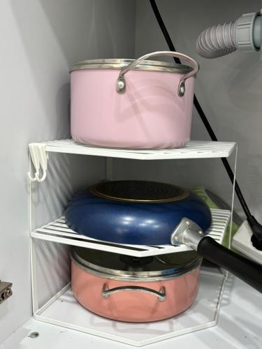 a shelf in a refrigerator with pots and pans at Sillim Leo's House in Seoul