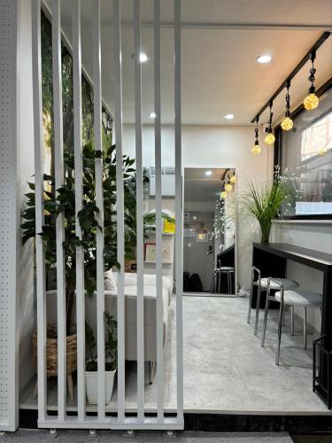 a room with a bed and a table with plants at Sillim Leo's House in Seoul