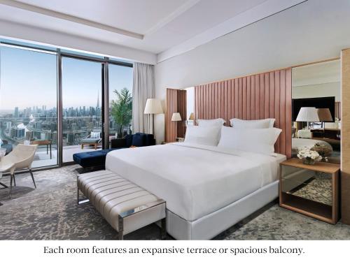 a hotel room with a large bed and a large window at SLS Dubai Hotel & Residences in Dubai