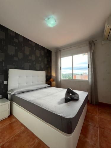 a bedroom with a large bed with a hat on it at El Balcón de Peñiscola in Peñíscola