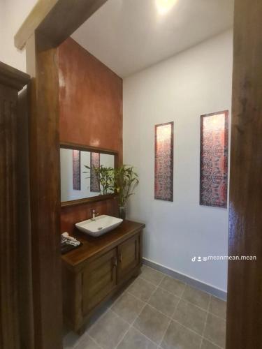 a bathroom with a sink and a mirror at Villa Romduol in Kampot