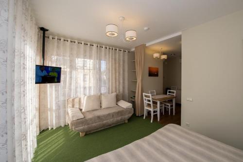 a living room with a couch and a table at Vila Levita in Palanga