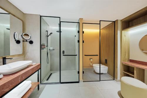 a bathroom with a glass shower and a toilet at Hyatt Centric Cairo West in Cairo