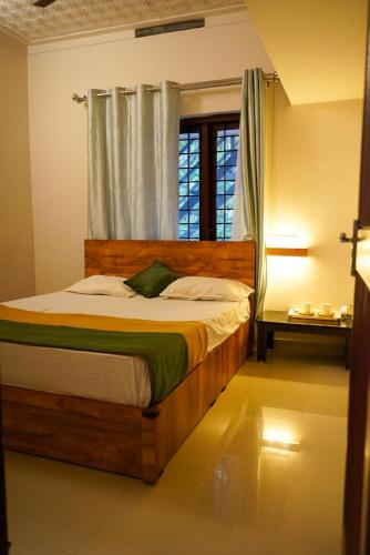 a bedroom with a wooden bed with a window at Misty Hills Cabin in Wayanad