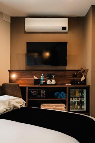 a hotel room with a flat screen tv on a wall at Royale Sainte Hélène Boutique Hotel in Birkirkara