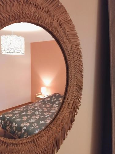 a mirror in the corner of a room with a bed at Maison Indépendante in Soissons-sur-Nacey