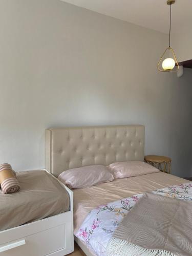 a bedroom with two twin beds and a lamp at Delima Cottage, a cozy studio in Melaka, Masjid Tanah in Masjid Tanah