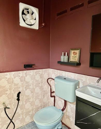 a bathroom with a toilet and a sink at Delima Cottage, a cozy studio in Melaka, Masjid Tanah in Masjid Tanah