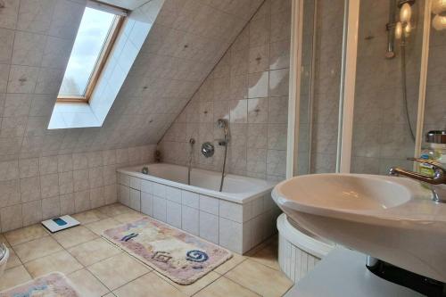 a bathroom with a tub and a sink and a bath tub at Apartment Kleine Auszeit in Wiendorf