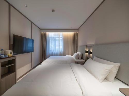 Ένα ή περισσότερα κρεβάτια σε δωμάτιο στο Hanting Hotel(Shanghai Lujiazui Minsheng Road Subway Station)