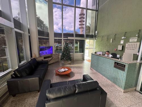a lobby with couches and a christmas tree in a building at Flat Sudoeste Vienna by CentoEdez in Brasilia