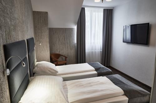 Postel nebo postele na pokoji v ubytování Hotel Baranowski