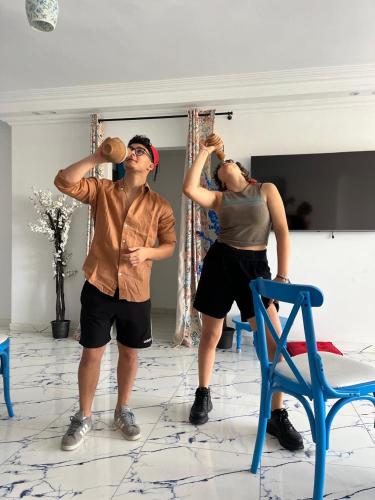 two men are standing in a room with their weights at Cairo Pyramids View Hostel & Apartment in Cairo