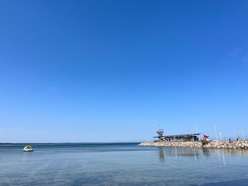 a small boat in the water next to a pier at Gasthaus & Pension "Zur Schaabe" in Glowe